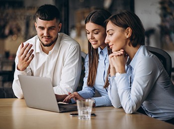 Group Of People Working Out Business Plan In An Office.
